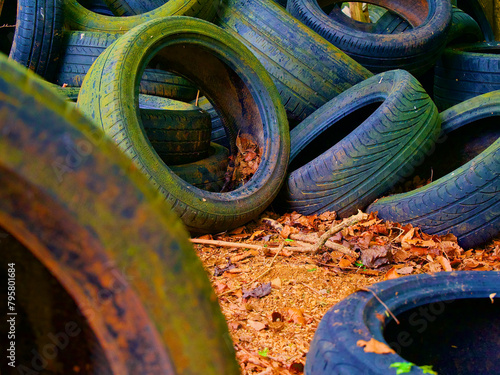 rubber tyres in a pile in the woods