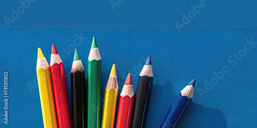 Colored pencils before blue background