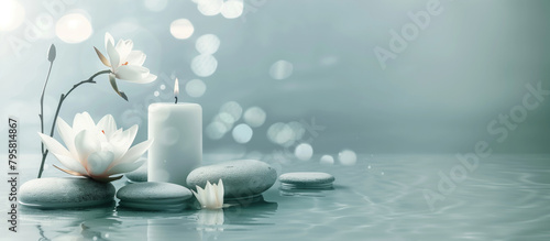 Tranquil spa setup with water lily, candle, and stones.