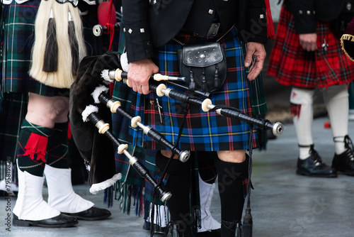 Traditional scottish bagpipers in kilts