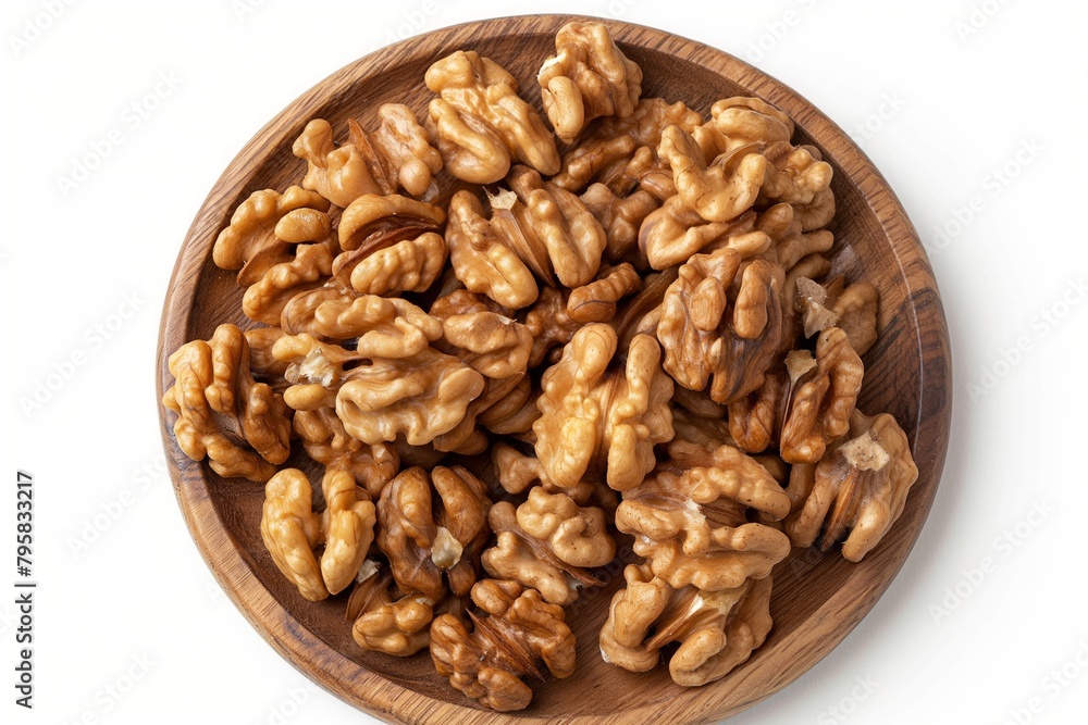 A plate of walnuts is on a wooden table. The walnuts are spread out and appear to be fresh A plate of walnuts is on a wooden table. The walnuts are spread out and appear to be fresh