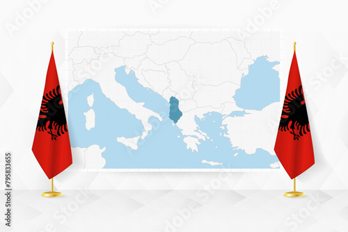 Map of Albania and flags of Albania on flag stand.