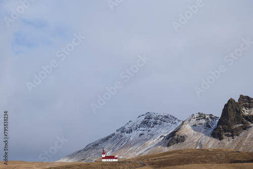 Reyniskirkja Church in Vik in Iceland with Mountain Range Landscape in Background