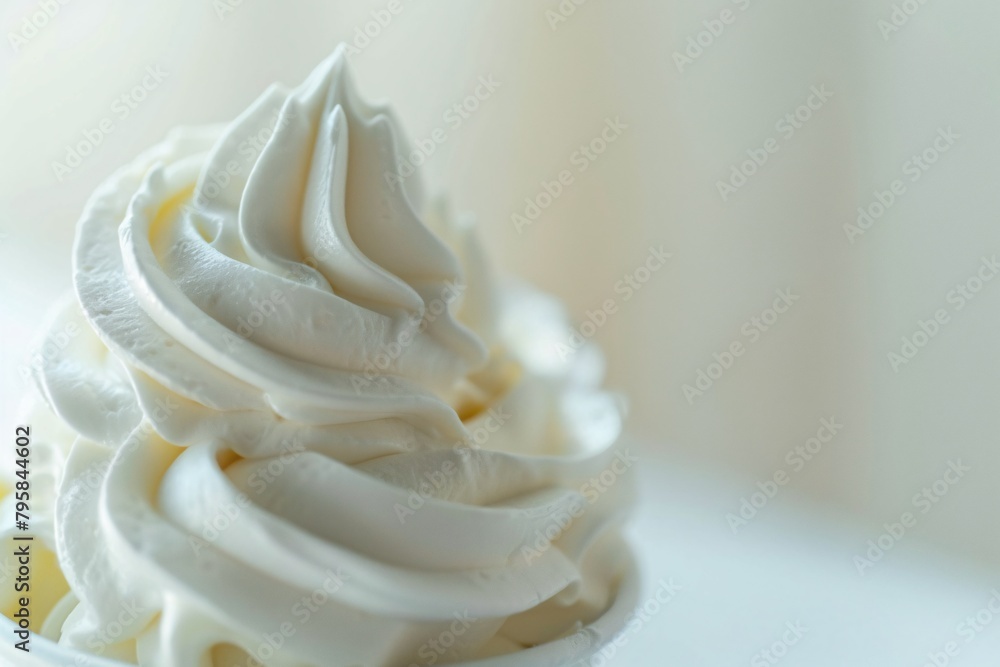 Close-up image of a creamy, smooth swirl of whipped cream in sharp detail against a soft background. Close-up image of a creamy, smooth swirl of whipped cream in sharp detail against a soft background.