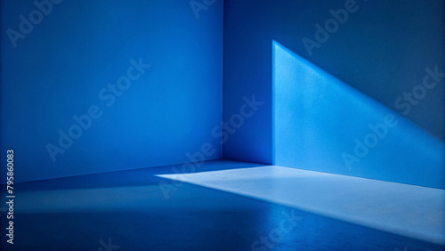 Empty blue gallery room with spotlights illuminating the blank walls 