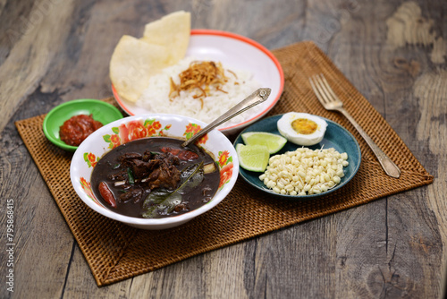 nasi rawon, black beef soup with rice.  Indonesian cuisine. photo
