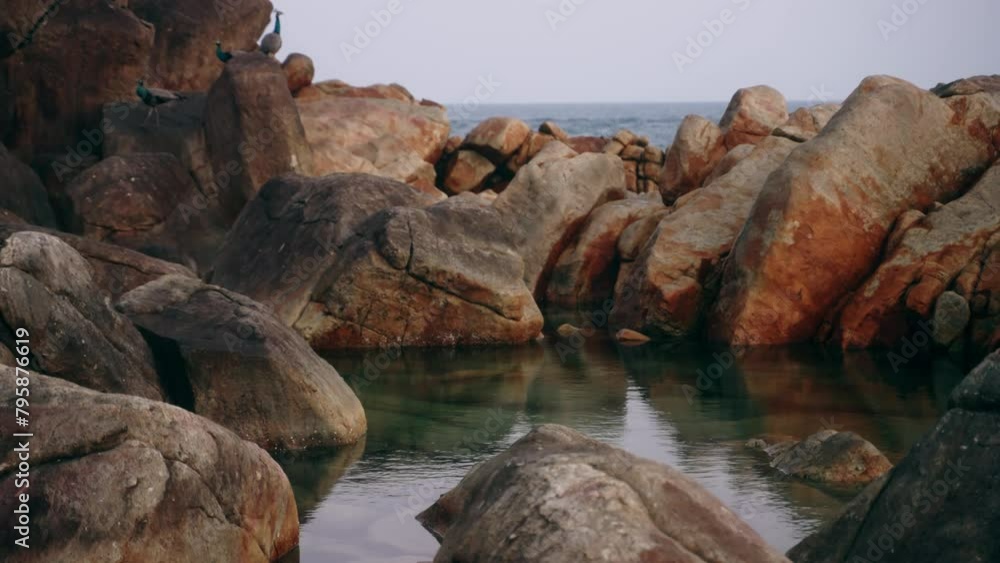 Natural rocky pool by sea, clear water forms tranquil oasis. Perfect for relaxation, nature scene inspires calm. Rocky landscape near ocean shores, exploration, quiet moments. Travel, eco-tourism. Natural rocky pool by sea, clear water forms tranquil oasis. Perfect for relaxation, nature scene inspires calm. Rocky landscape near ocean shores, exploration, quiet moments. Travel, eco-tourism.