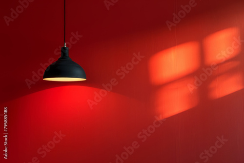 A lamp hangs against a red wall, casting its light and illuminating the area, with space available for text or presentation.