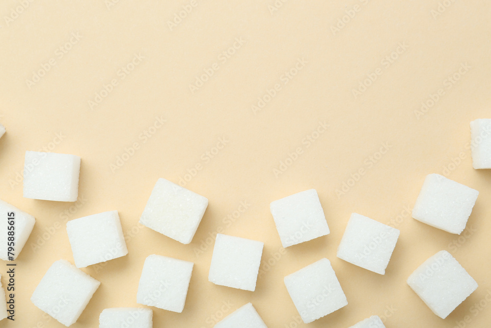 White sugar cubes on beige background, top view. Space for text White sugar cubes on beige background, top view. Space for text