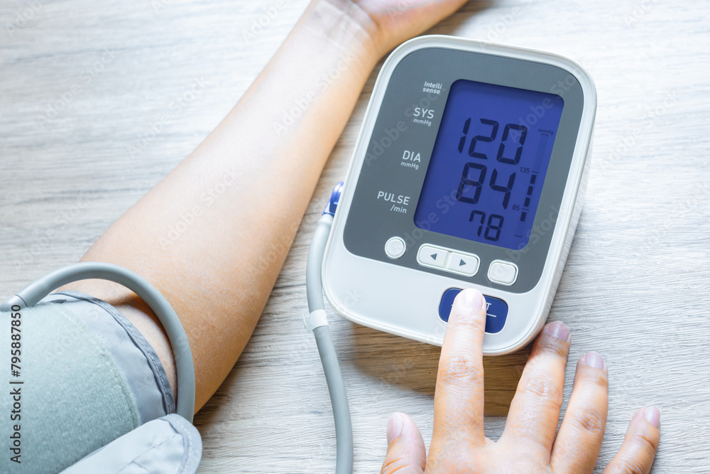 Man check blood pressure monitor and heart rate monitor with digital pressure gauge. Health care and Medical concept Man check blood pressure monitor and heart rate monitor with digital pressure gauge. Health care and Medical concept