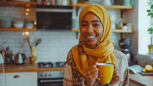 Joyful Morning Ritual Biracial Woman in Hijab Savoring Coffee in Kitchen