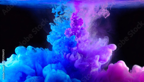 Splash of purple and blue paint mix in water on black background. Abstract ink clouds of cold colors mixing inside a transparent liquid on a dark surround.