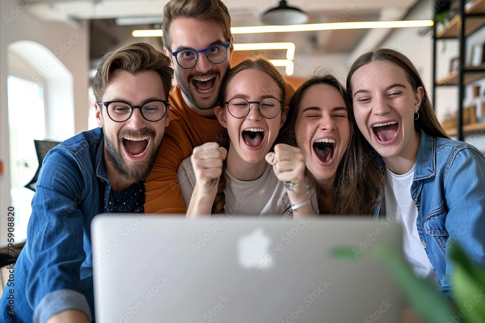 Group of happy young people sitting in front of a laptop computer and laughing. Group of happy young people sitting in front of a laptop computer and laughing.