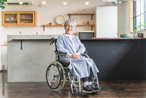 自宅のダイニングで車椅子に座る高齢者女性 