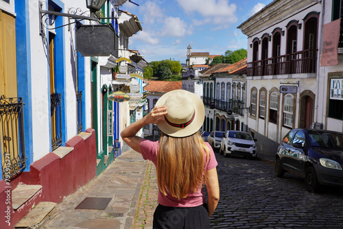 Holidays in Ouro Preto, Brazil. Rear view of tourist woman descends street in the historic city of Ouro Preto, UNESCO World Heritage Site, Minas Gerais, Brazil. photo