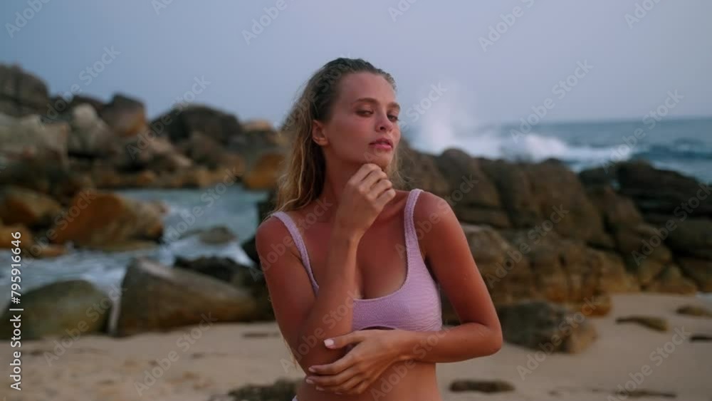 Serene woman in bikini relishes beach sunset. Tranquil ocean breeze, sandy shores surround as she savors cotton candy skies after an ocean dip. Peaceful, reflective moment celebrates wellness, beauty. Serene woman in bikini relishes beach sunset. Tranquil ocean breeze, sandy shores surround as she savors cotton candy skies after an ocean dip. Peaceful, reflective moment celebrates wellness, beauty.