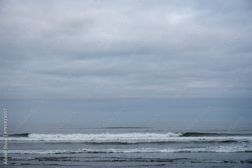 Small Waves Crash Along The Washington Coast On A Cloudy Day