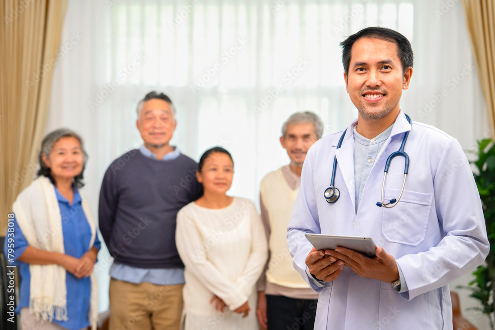 portrait of a mature man doctor in uniform with stethoscope using digital tablet in home health care work,background group of senior patient family,concept for caring for the elderly,health insurance portrait of a mature man doctor in uniform with stethoscope using digital tablet in home health care work,background group of senior patient family,concept for caring for the elderly,health insurance