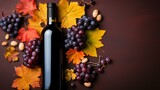 b'A bottle of red wine with grapes and fall leaves'