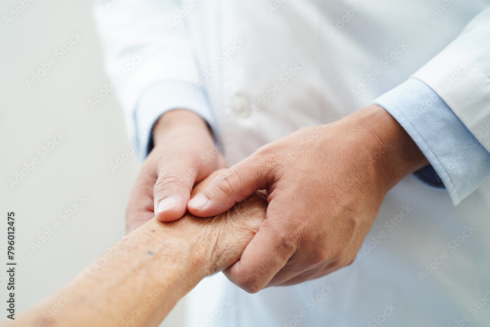 Doctor holding hands Asian elderly woman patient, help and care in hospital.