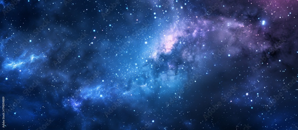 Fototapeta premium Captivating image of a swirling galaxy in stunning shades of blue and purple, adorned with twinkling stars against a deep black background