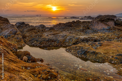 Coastal rocks at sunset. © imphilip