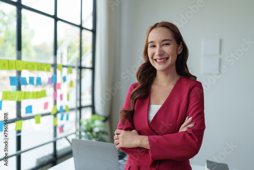 Asian businesswoman smiling confidently A successful entrepreneur in the financial business professional company executive wearing a suit standing with arms crossed in the office. Free Download Asian businesswoman smiling confidently A successful entrepreneur in the financial business professional company executive wearing a suit standing with arms crossed in the office. - GFXLoad