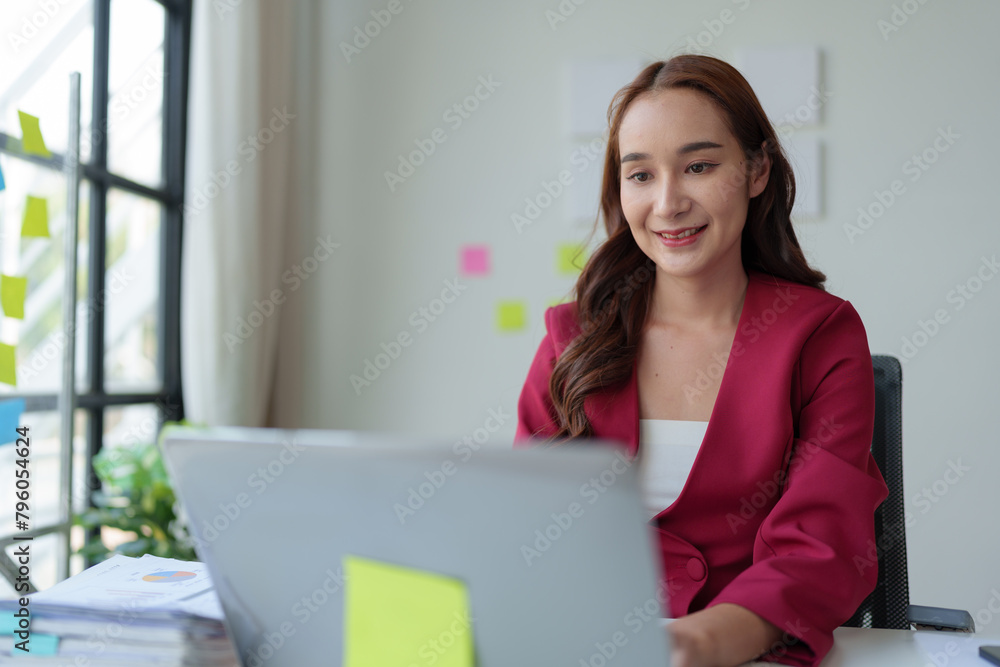 Asian businesswoman, self-employed working on laptop computer typing e-commerce marketing financial report on real estate project in office management concept. Asian businesswoman, self-employed working on laptop computer typing e-commerce marketing financial report on real estate project in office management concept.