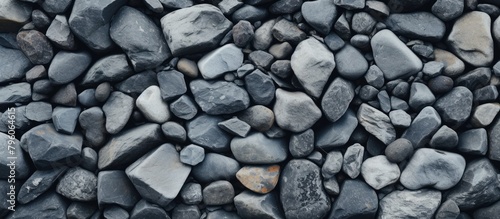 A stack of cobblestone rocks forms a natural art piece on the beach