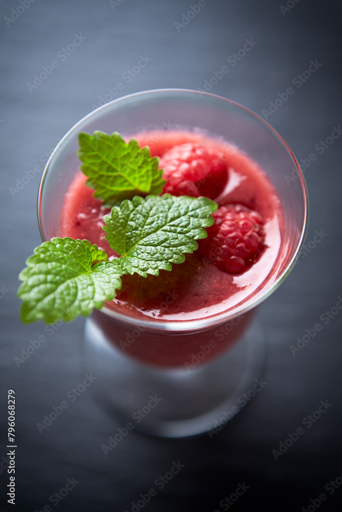 Fresh smoothie in a glass. Dark background. Close up. Fresh smoothie in a glass. Dark background. Close up.