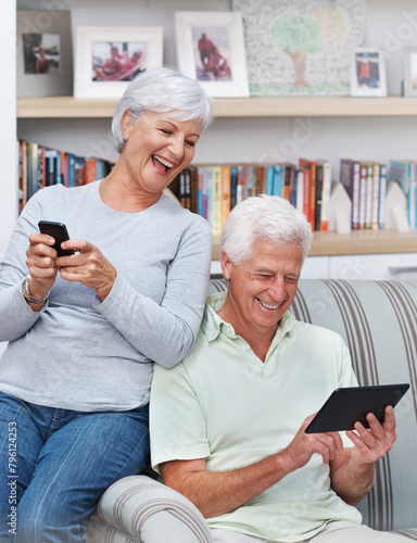 Senior couple, tablet and laugh for joke in home, comedy and streaming comic on social media. Elderly people, funny internet blog and relax on couch, bonding and happy in retirement for online love