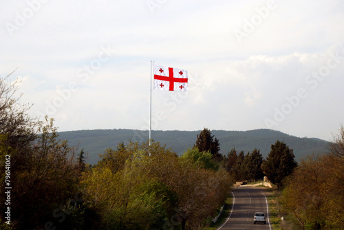 georgian national flag flying on the sky with landscape background