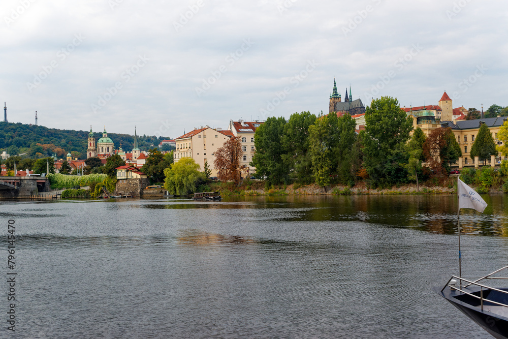 Scenic view of Moldova River with famous castle and cathedral of Czech City of Prague on a cloudy autumn day. Photo taken October 10th, 2023, Prague, Czechia.
