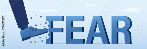Businessman boot kicking hard the giant FEAR word. Overcoming fear and scare concept. Overcome mental and psychological problems.