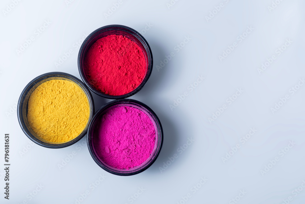 Colorful holi powder in a bowl isolated on white background. Colorful holi powder in a bowl isolated on white background.