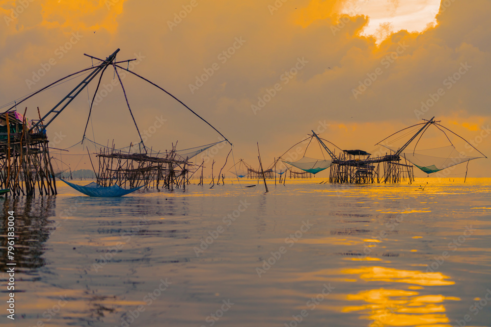 Yor Yak or Thai giant fishing gear with golden morning light, and beautiful sunrise scenery at Pakpra canal, Phatthalung, Thailand.