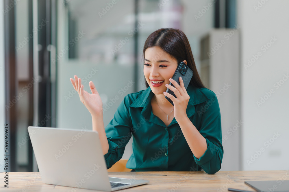 Portrait of beautiful asian secretary woman working with cellphone and desktop in office. Portrait of beautiful asian secretary woman working with cellphone and desktop in office.