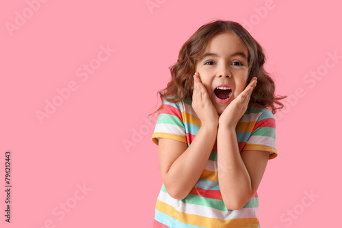 Shocked little girl on pink...