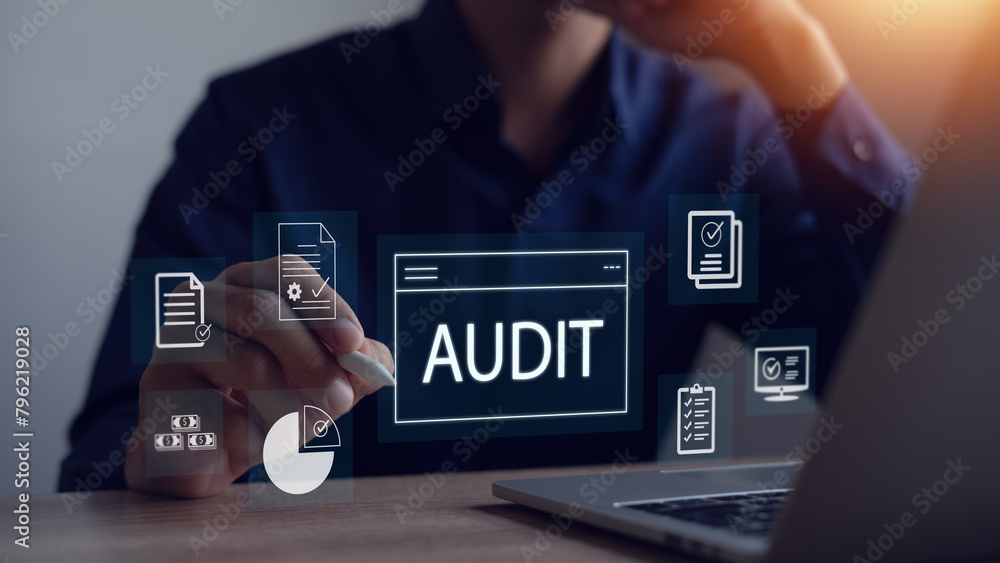 Naklejka premium Businessman uses laptop computer to audit internal financial accounts and evaluate company financial statements.