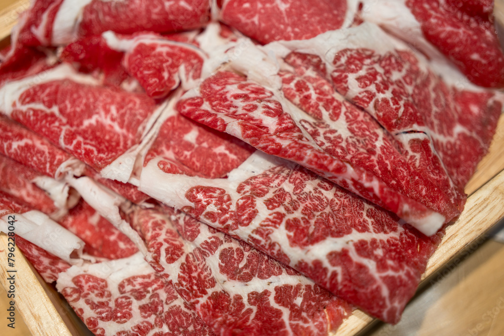 Premium Japanese meat sliced wagyu marbled beef in wood box. Top view Premium Japanese meat sliced wagyu marbled beef in wood box. Top view