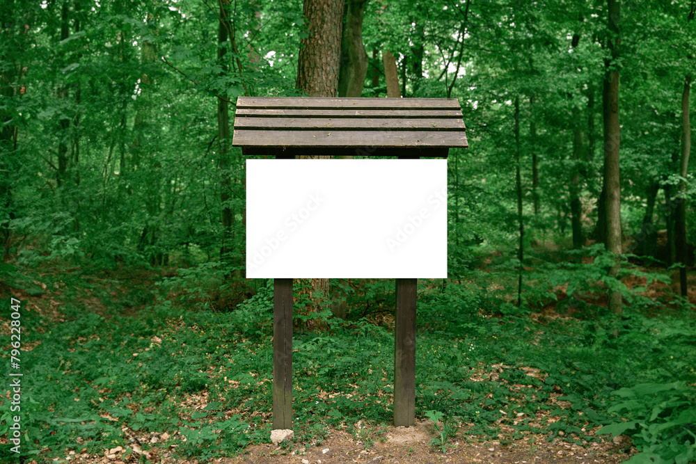 Blank sign on the hiking path in the woods