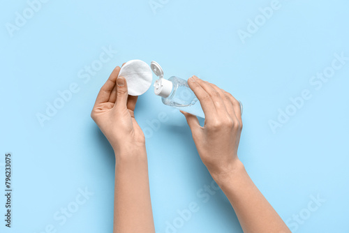 Female hands with bottle of...