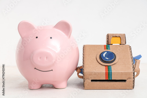 Piggy bank with paper camer...