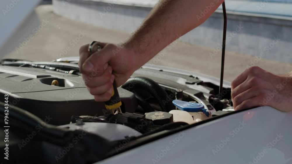 Mechanical engineer repairs car with wrench addressing issues. Meticulous approach automotive repair exemplifies commitment to excellence practiced at auto service standards of quality car repairs. Mechanical engineer repairs car with wrench addressing issues. Meticulous approach automotive repair exemplifies commitment to excellence practiced at auto service standards of quality car repairs.