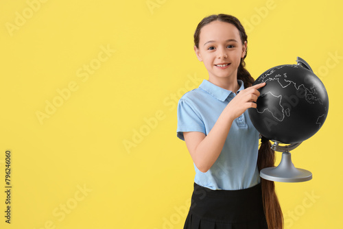 Smiling schoolgirl pointing...