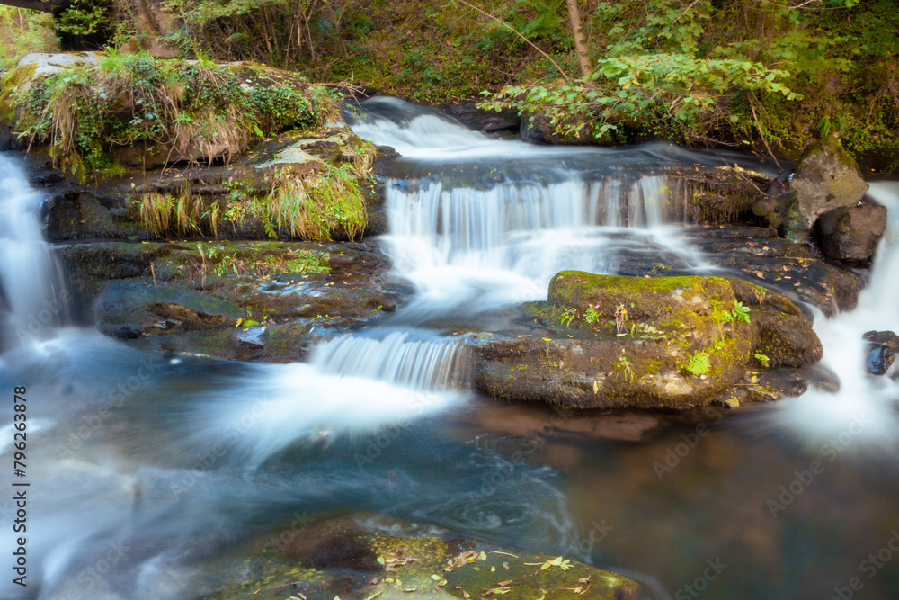 Fototapeta premium Small waterfall in the Pisueña river in autumn. Long exposure photography