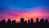 Silhouettes of buildings against a colorful sunrise sky in the city, awakening urban landscapes