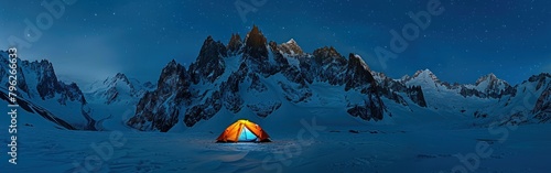 A tent is pitched up in the snow with towering mountains in the background photo