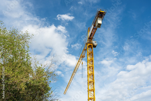 Construction crane working on large construction site © yalcinsonat