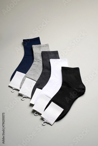 Mens new socks on a gray background, close-up. Cotton socks with blank label